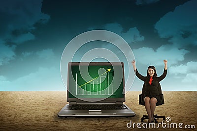 Business person looking giant laptop on the desert Stock Photo