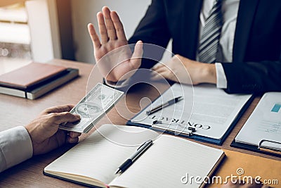 Business person refusing bribe given money by partner with anti bribery corruption concept Stock Photo