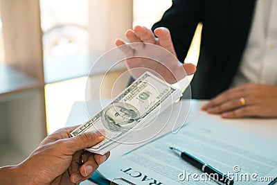 Business person refusing bribe given money by partner with anti bribery corruption concept Stock Photo