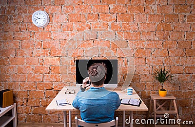 Business person sitting at office desk, talking on phone Stock Photo