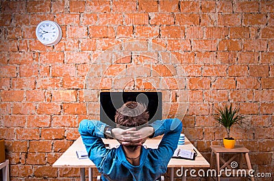 Business person sitting at office desk wearing smart watch Stock Photo