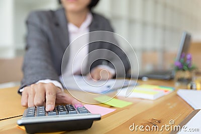 Business person using a calculator to calculate the numbers. Accounting , Accountancy, Calculation Concept. Stock Photo