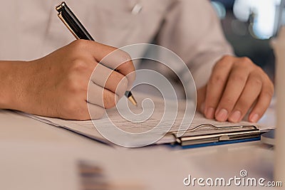 Business person Writing contract law and paper work for business and finance investments , write document, complete job Stock Photo