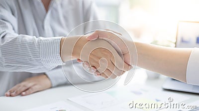 Business personage handshake, Asian business women congratulate on being a corporate partnership with European male investors Stock Photo