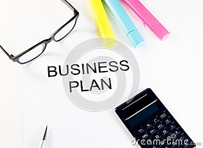 Business plan words near highlighters, calculator and glasses, business concept Stock Photo