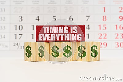 Against the background of the calendar, cubes and a plate with the inscription - Timing is Everything Stock Photo