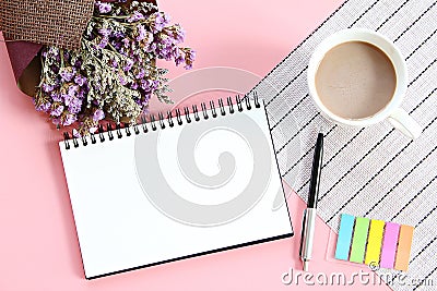 Top view or flat lay of open notebook paper, bouquet of dried wild flowers and coffee cup on desk table Stock Photo