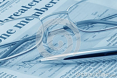 Business press, glasses and pen (blue toned) Stock Photo