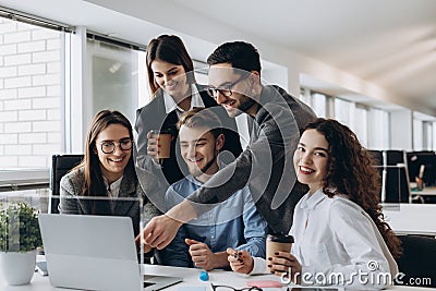 Business professionals. Group of young confident business people analyzing data using computer while spending time in the office Stock Photo