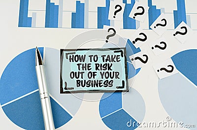 On the blue diagrams lies a pen, questions and a sticker with the inscription -How To Take the Risk Out of Your Business Stock Photo