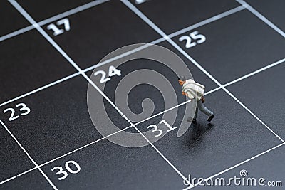 Business schedule plan, travel date or end of month pay day for salary man concept, miniature people businessman figure with Stock Photo