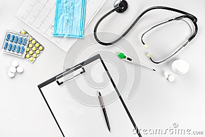 Business set for hospital: pills, stethoscope, medical equipment, note book with pen and mask on white background Stock Photo