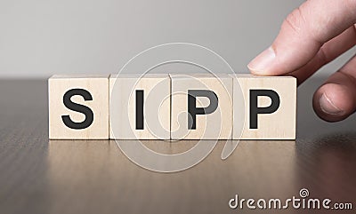 Business sipp concept. Hand and fake on wood cube block Stock Photo