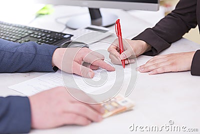 Business situation. Busineswoman signing loan contract,with money, Euro banknotes on Stock Photo