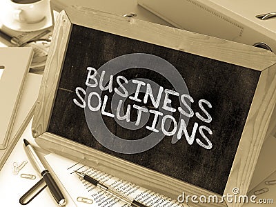 Business Solutions Handwritten by white Chalk on a Stock Photo