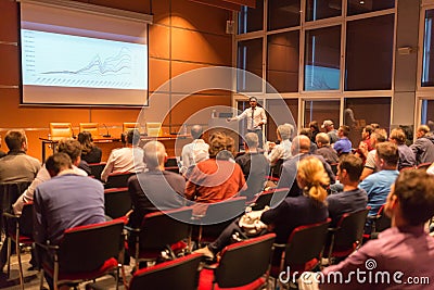 Business speaker giving a talk in conference hall. Editorial Stock Photo