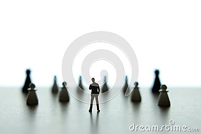 Silhouette of miniature of businessman thinking in front of chess pawn Stock Photo