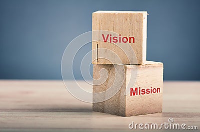 word VISION MISSION on wooden cube over gently lit dark background Stock Photo