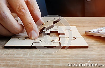 Business success and problem solving. Man holds piece of puzzle Stock Photo