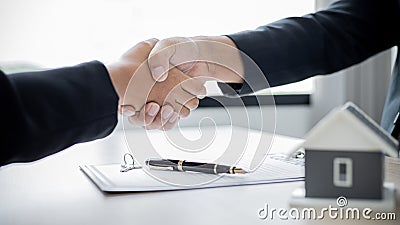 Business success, Real estate agents and customers shake hands to congratulate after signing a contract to buy a house Stock Photo