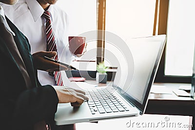 Business team analyzing income charts and graphs with modern laptop computer. Stock Photo