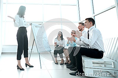 Business team applauds the businesswoman at the presentation of the new project. Stock Photo