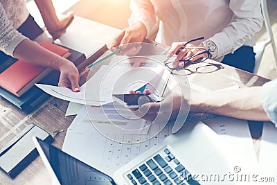 Business team brainstorming. Marketing plan researching. Paperwork on the table, laptop and smartphone Stock Photo