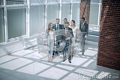 Business team, businesspeople group walking at modern bright office interior Stock Photo