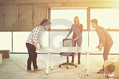 Business team carrying white table Stock Photo