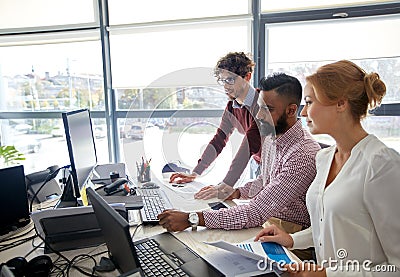 Business team with computers and papers at office Stock Photo