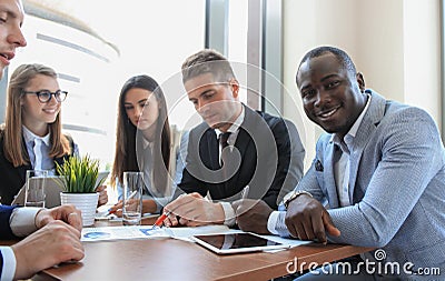 Business team discussing together business plans in office. Stock Photo