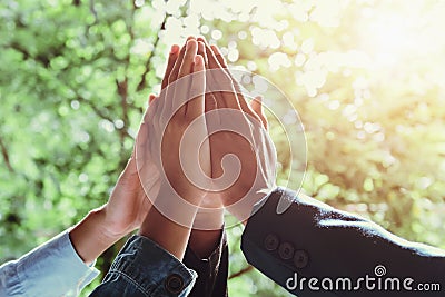 business team giving high five with sunshine background Stock Photo