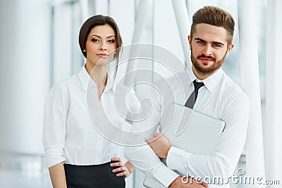 Business Team. Happy smiling people standing in office Stock Photo