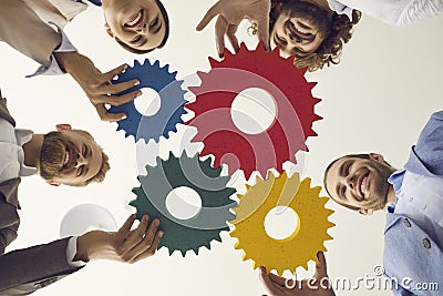 Business team joining cog wheels to illustrate concept of effective strategy and teamwork Stock Photo