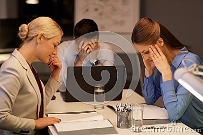 Business team with laptop working late at office Stock Photo