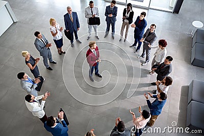 Business team with leader in centre of circle Stock Photo