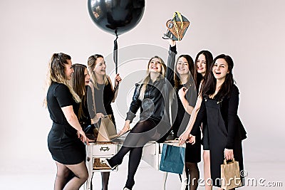 Business team of sexy attractive women celebrating female colleague`s birthday in studio. Friends meeting, Birthday Stock Photo