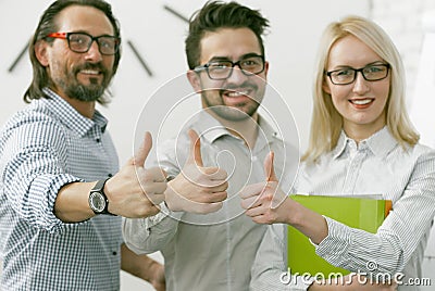 Business Team showing thumbs up gesture. Office workers expressing a positive mood is showing a thumb up sign meaning Stock Photo