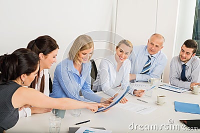 Business Team Sitting Around Meeting Table Stock Photo