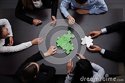 Business team solving puzzle Stock Photo