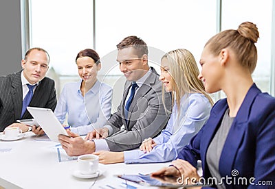 Business team with tablet pc having discussion Stock Photo