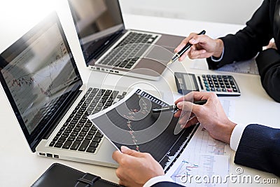 Business Team trader or broker Investment Entrepreneur colleagues working discussing and analysis graph stock market trading with Stock Photo