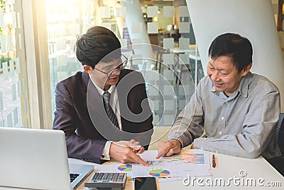 Business team two colleagues discussing working with many document graph in team Meeting Talking Brainstorming Communication Stock Photo