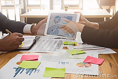 Business team working on tablet and documents at workplace wooden desk in office. Business Team Corporate Organization Working Co Stock Photo