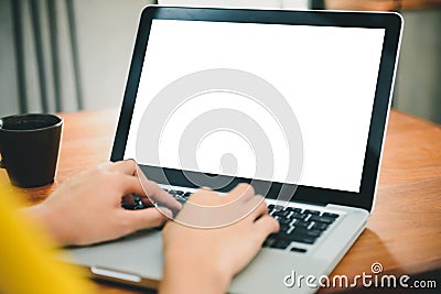 Woman hands typing laptop computer with blank screen on table in coffee shop. Stock Photo