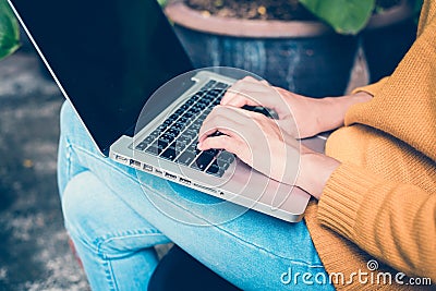 Business Technology Concepts - Digital lifestyle working outside office. Woman hands typing laptop computer with blank screen. Stock Photo