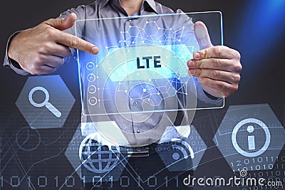 Business, Technology, Internet and network concept. Young businessman showing a word in a virtual tablet of the future: LTE Stock Photo