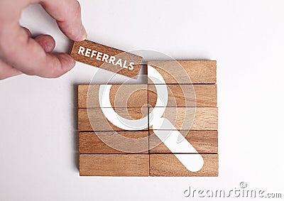 Business, Technology, Internet and network concept. Young businessman shows the word: Referrals Stock Photo