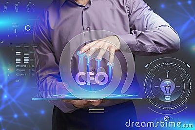 Business, Technology, Internet and network concept. Young businessman shows the word on the virtual display of the future: CFO Stock Photo