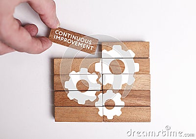 Business, Technology, Internet and network concept. Young businessman shows the word: Continuous improvement Stock Photo